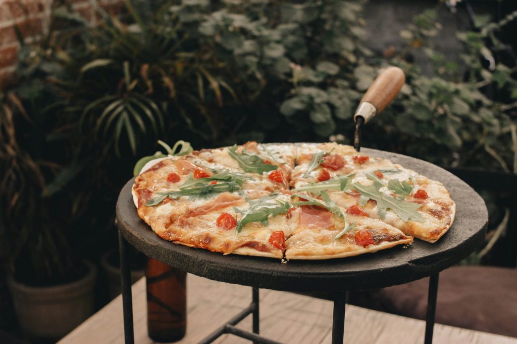 a pizza sitting on top of a black table